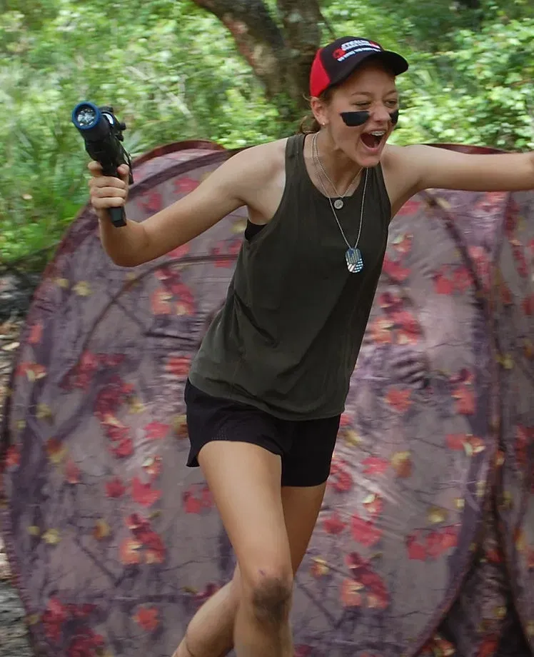 Young player celebrating during an outdoor Stealth mobile laser tag mission